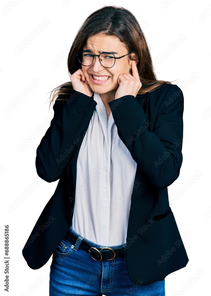 Young caucasian girl wearing business style and glasses covering ears with fingers with annoyed expression for the noise of loud music. deaf concept. Young caucasian girl wearing business style and glasses covering ears with fingers with annoyed expression for the noise of loud music. deaf concept.