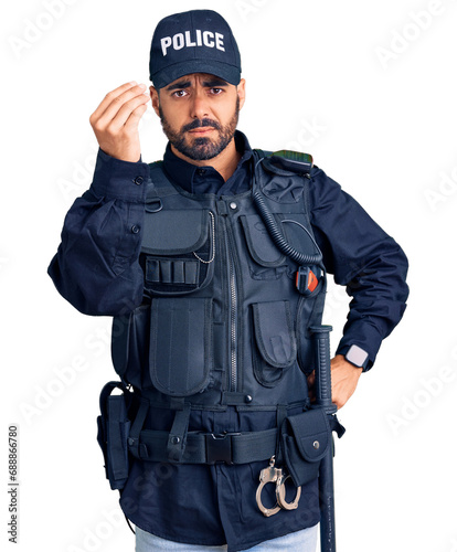 Young hispanic man wearing police uniform doing italian gesture with hand and fingers confident expression