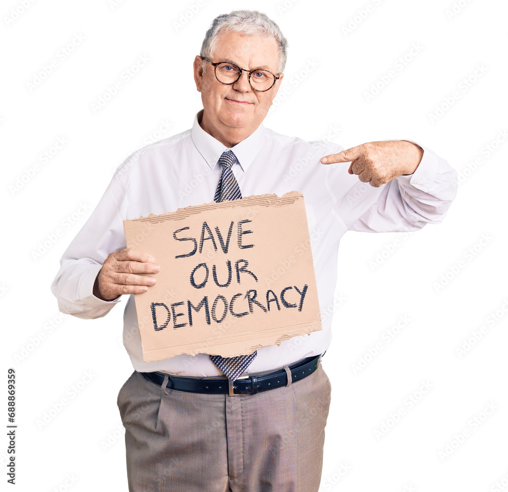 Senior grey-haired man wearing business clothes holding save our democracy protest banner pointing finger to one self smiling happy and proud Senior grey-haired man wearing business clothes holding save our democracy protest banner pointing finger to one self smiling happy and proud