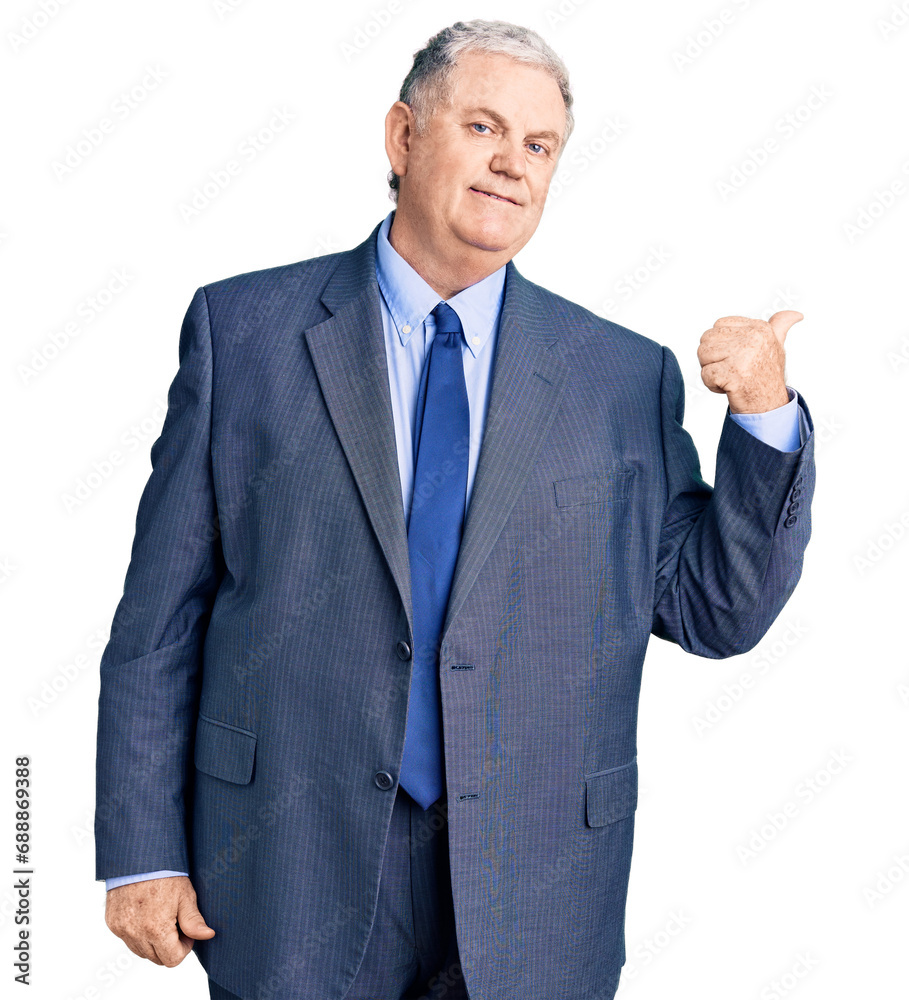 Senior grey-haired man wearing business jacket smiling with happy face looking and pointing to the side with thumb up. Senior grey-haired man wearing business jacket smiling with happy face looking and pointing to the side with thumb up.