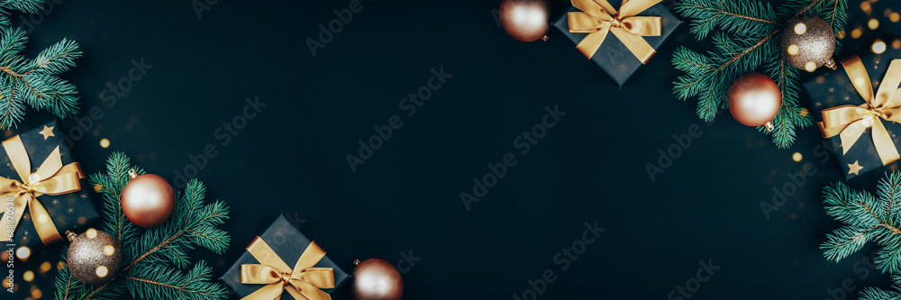 Banner with golden Christmas balls, gifts and decorations on black background with bokeh lights. Festive flat lay. Top view, copy space