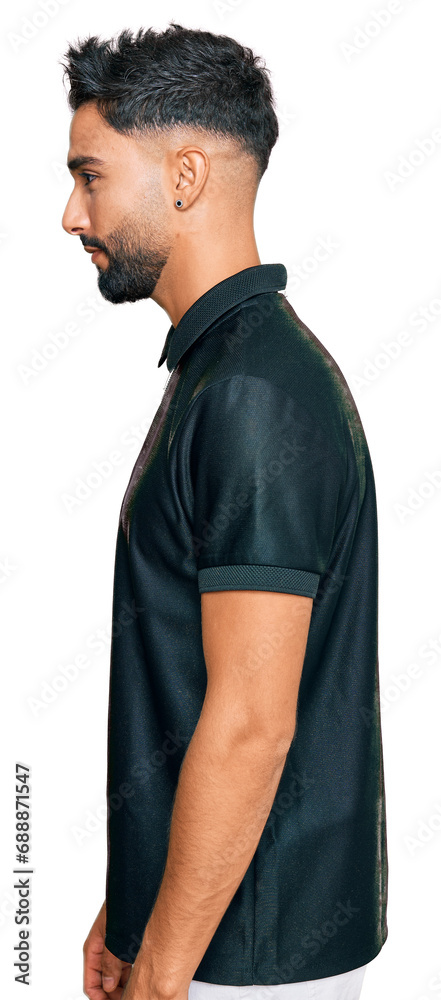 Young man with beard wearing sportswear looking to side, relax profile pose with natural face with confident smile. Young man with beard wearing sportswear looking to side, relax profile pose with natural face with confident smile.