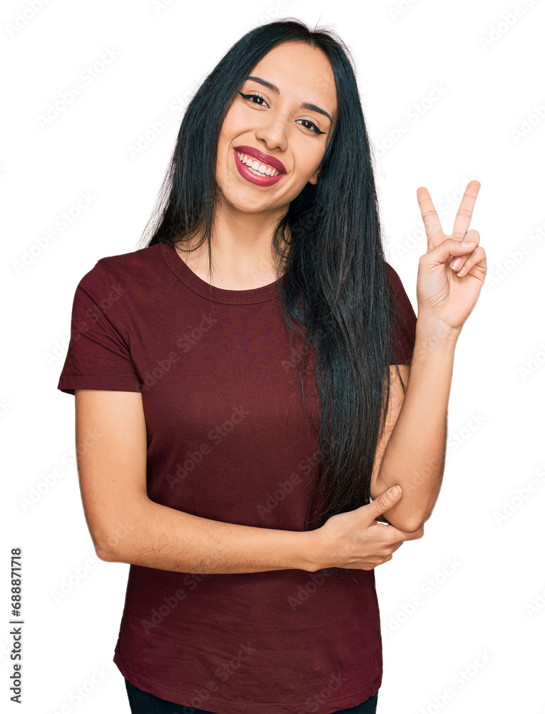 Young hispanic girl wearing casual t shirt smiling with happy face winking at the camera doing victory sign. number two. Young hispanic girl wearing casual t shirt smiling with happy face winking at the camera doing victory sign. number two.