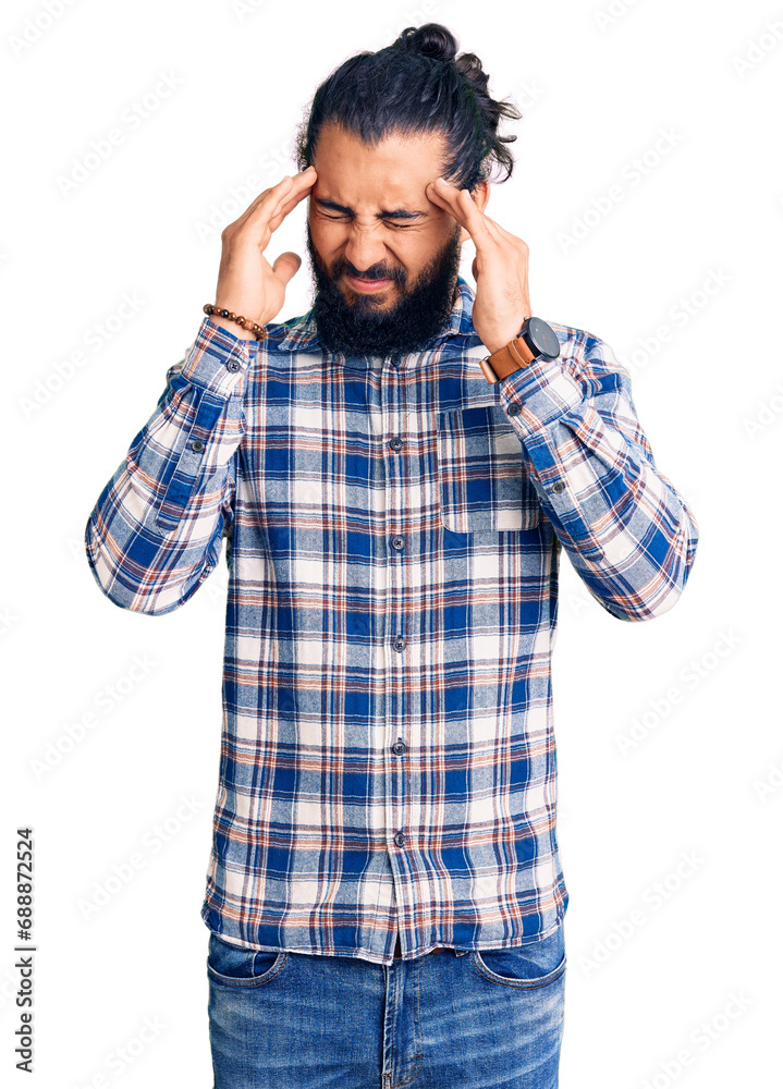 Young arab man wearing casual clothes with hand on head for pain in head because stress. suffering migraine. Young arab man wearing casual clothes with hand on head for pain in head because stress. suffering migraine.