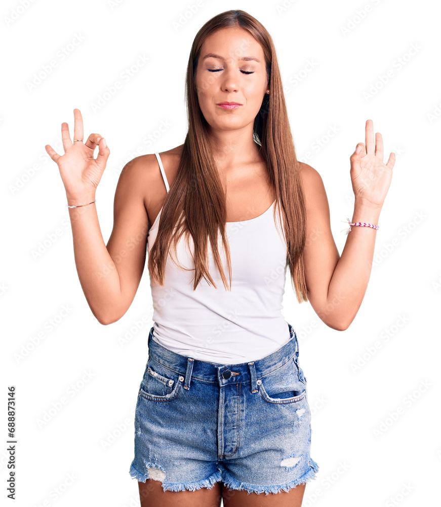 Young beautiful hispanic woman wearing casual clothes relax and smiling with eyes closed doing meditation gesture with fingers. yoga concept. Young beautiful hispanic woman wearing casual clothes relax and smiling with eyes closed doing meditation gesture with fingers. yoga concept.