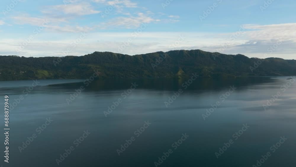 Top view of lake Toba among the mountains with rainforest. Sumatra, Indonesia. Top view of lake Toba among the mountains with rainforest. Sumatra, Indonesia.
