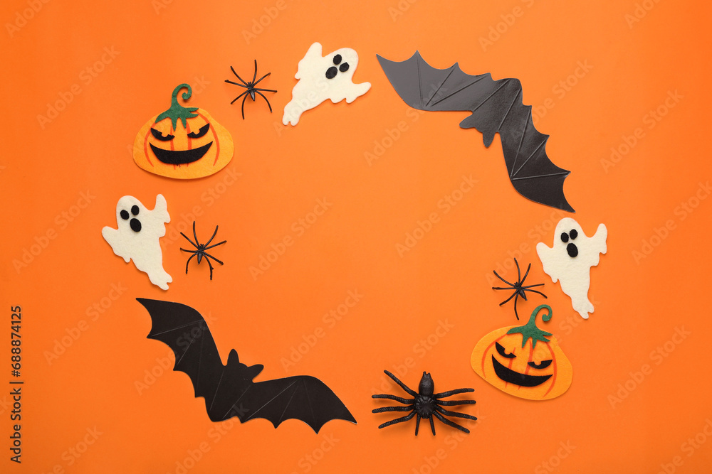 Obraz premium Frame made of cardboard bats, felt pumpkins, ghosts and spiders on orange background, space for text. Halloween celebration