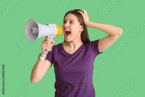 Young woman shouting into m...