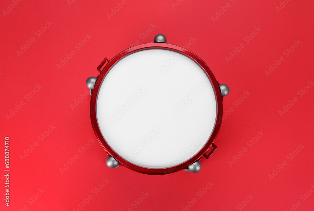 Drum on red background, top view. Percussion musical instrument