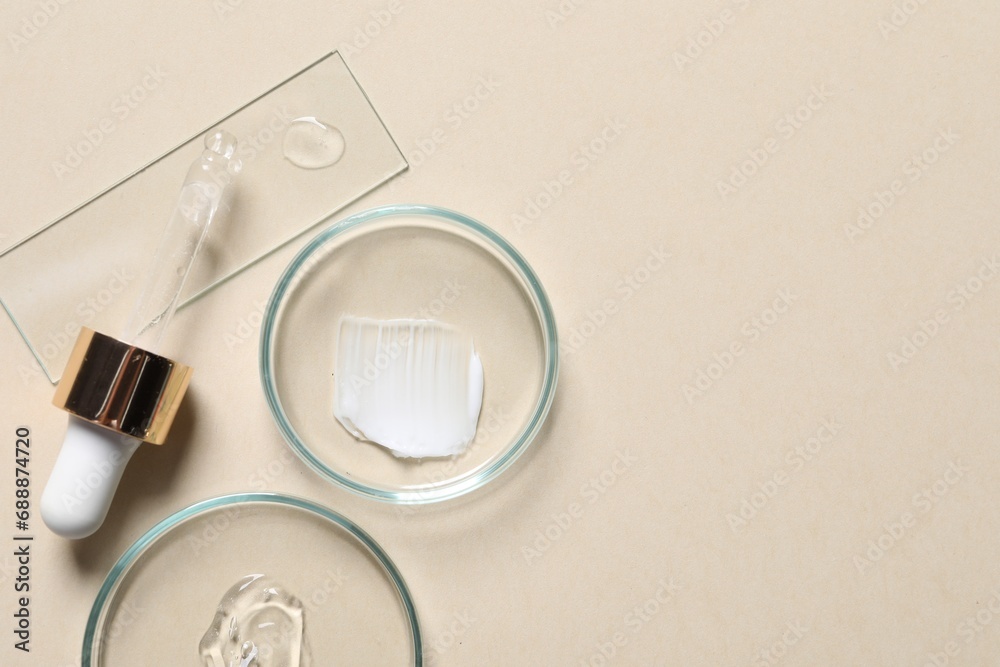 Pipette, cosmetic serum and petri dishes with samples on beige background, flat lay. Space for text