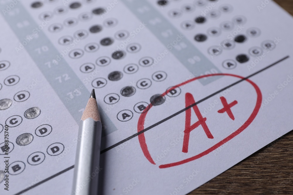 Fototapeta premium School grade. Answer sheet with red letter A, plus symbol and pencil on wooden table, closeup