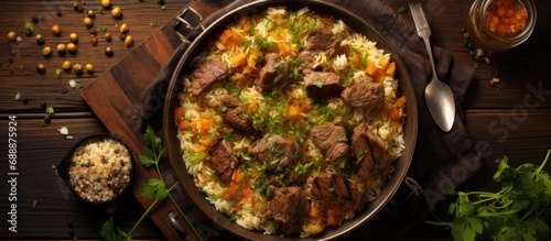Plov, a national Middle Asian dish, shown in a top-down view with sliced meat, garlic, and presented in a high-quality flat lay, representing its international appeal. photo