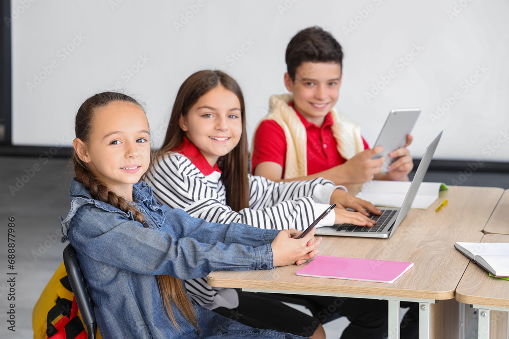 Little children studying with devices at school computer lab Little children studying with devices at school computer lab