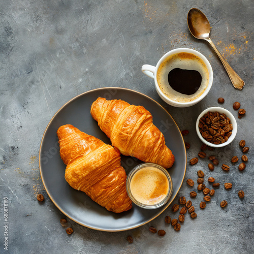 Croissants with coffee. Two French croissants on plate and cup of espresso coffee on concrete background, top view