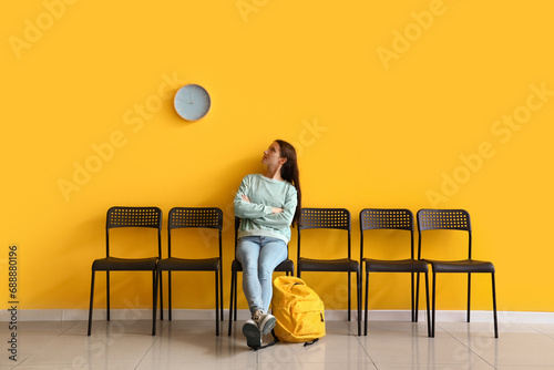 Young woman waiting for her turn in room photo