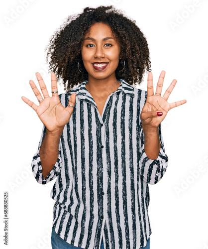 Young african american girl wearing casual clothes showing and pointing up with fingers number nine while smiling confident and happy. © Krakenimages.com