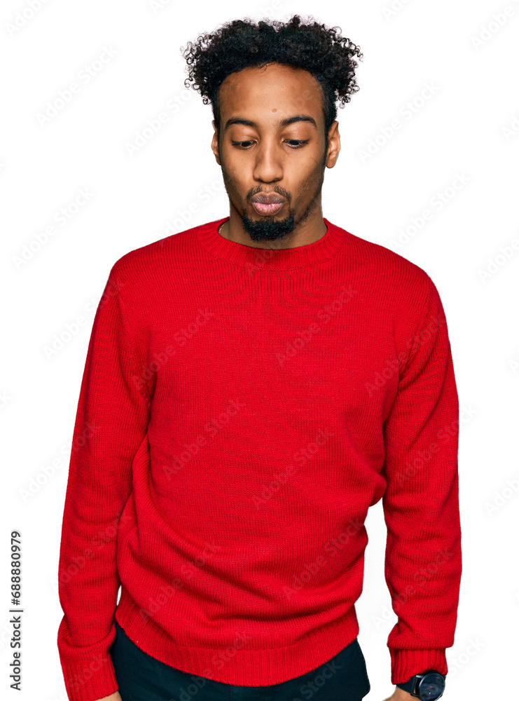 Young african american man with beard wearing casual winter sweater making fish face with lips, crazy and comical gesture. funny expression. Young african american man with beard wearing casual winter sweater making fish face with lips, crazy and comical gesture. funny expression.