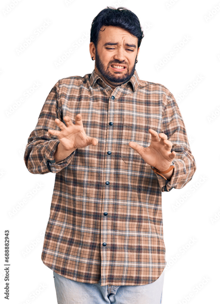Young hispanic man wearing casual clothes disgusted expression, displeased and fearful doing disgust face because aversion reaction. Young hispanic man wearing casual clothes disgusted expression, displeased and fearful doing disgust face because aversion reaction.