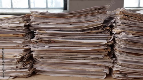 Stack business paper on desk, paperwork in office. Piled heap high documents folders photo