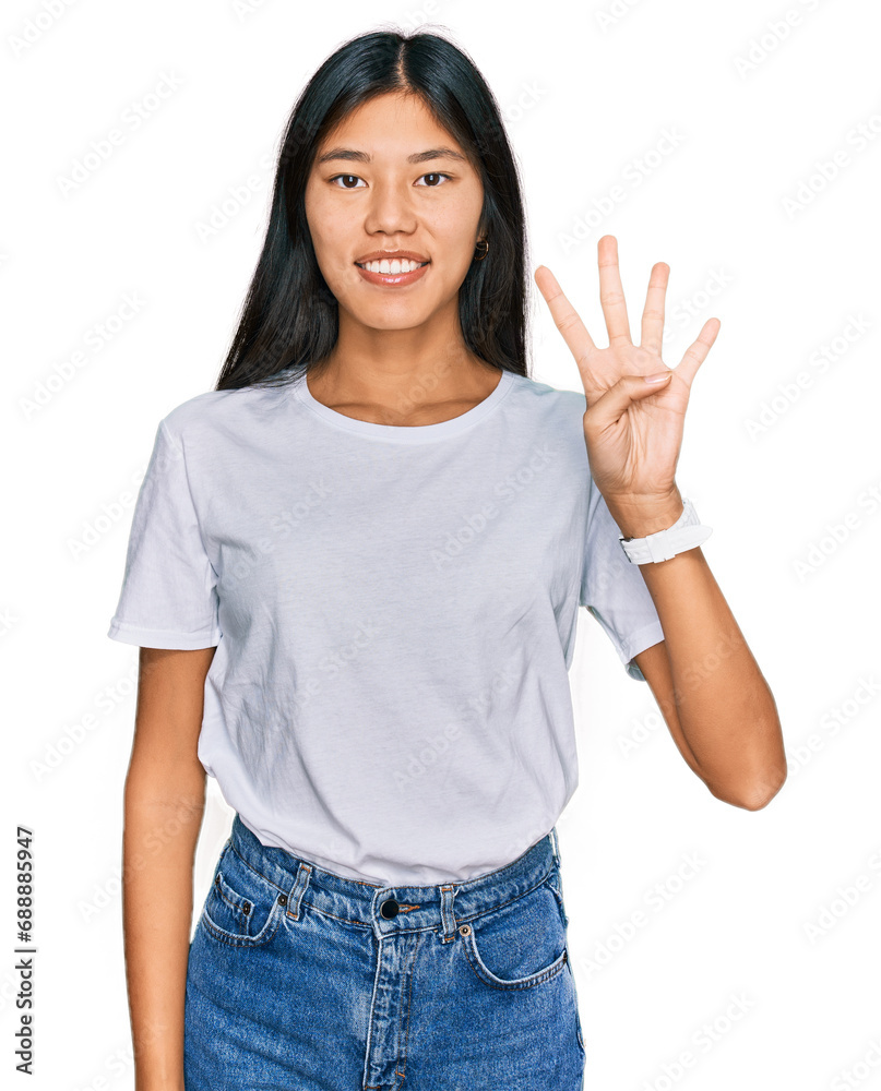 Beautiful young asian woman wearing casual white t shirt showing and pointing up with fingers number four while smiling confident and happy. Beautiful young asian woman wearing casual white t shirt showing and pointing up with fingers number four while smiling confident and happy.