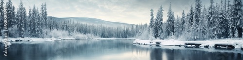 Beautiful white winter wonderland scenery with crystal clear lake in forest on cold sunny day with blue sky and clouds. Frosty cold winter day. Big lake in the woods. Winter Christmas landscape