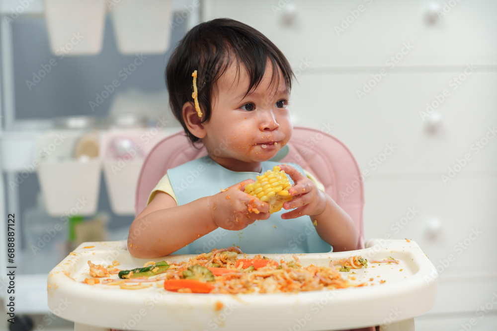 infant baby eating food and vegetable by self feeding BLW or baby led weaning on chair infant baby eating food and vegetable by self feeding BLW or baby led weaning on chair