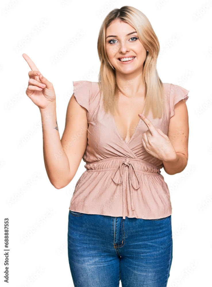 Young caucasian woman wearing casual clothes smiling and looking at the camera pointing with two hands and fingers to the side. Young caucasian woman wearing casual clothes smiling and looking at the camera pointing with two hands and fingers to the side.