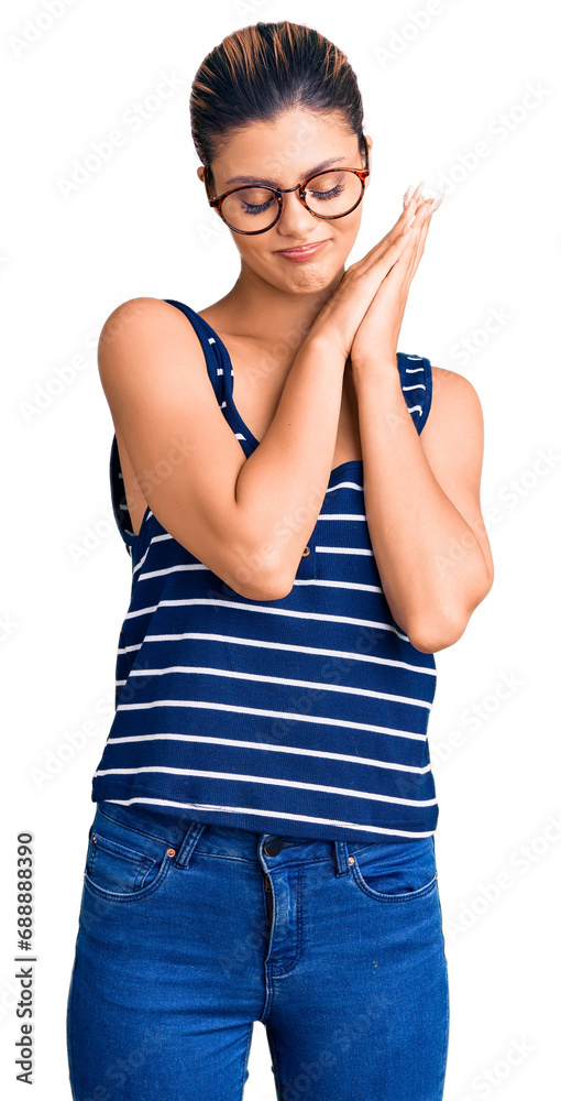 Φωτογραφία Young beautiful woman wearing casual clothes and glasses sleeping tired dreaming and posing with hands together while smiling with closed eyes