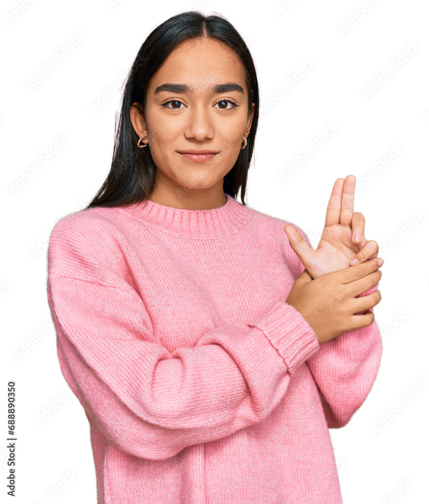 Young asian woman wearing casual winter sweater holding symbolic gun with hand gesture, playing killing shooting weapons, angry face Young asian woman wearing casual winter sweater holding symbolic gun with hand gesture, playing killing shooting weapons, angry face