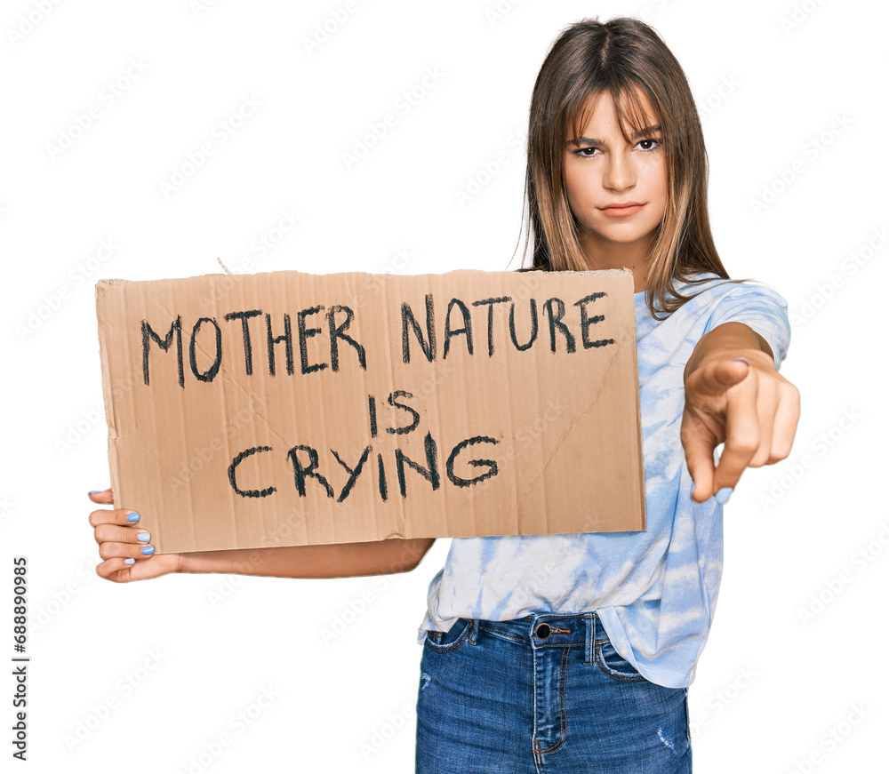 Teenager caucasian girl holding mother nature is crying protest cardboard banner pointing with finger to the camera and to you, confident gesture looking serious Teenager caucasian girl holding mother nature is crying protest cardboard banner pointing with finger to the camera and to you, confident gesture looking serious