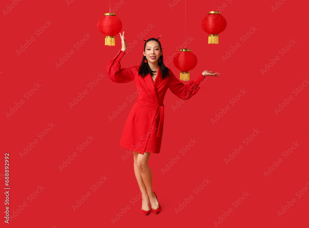 Beautiful young Asian woman with lanterns on red background. Chinese New Year celebration Beautiful young Asian woman with lanterns on red background. Chinese New Year celebration