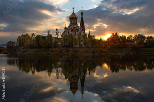 Orthodox church on the shore of a pond in the Kazakh city of Almaty at sunset