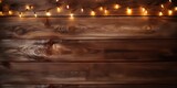 Holiday lights casting a warm glow on a dark wooden background, creating mesmerizing light patterns and shadows.