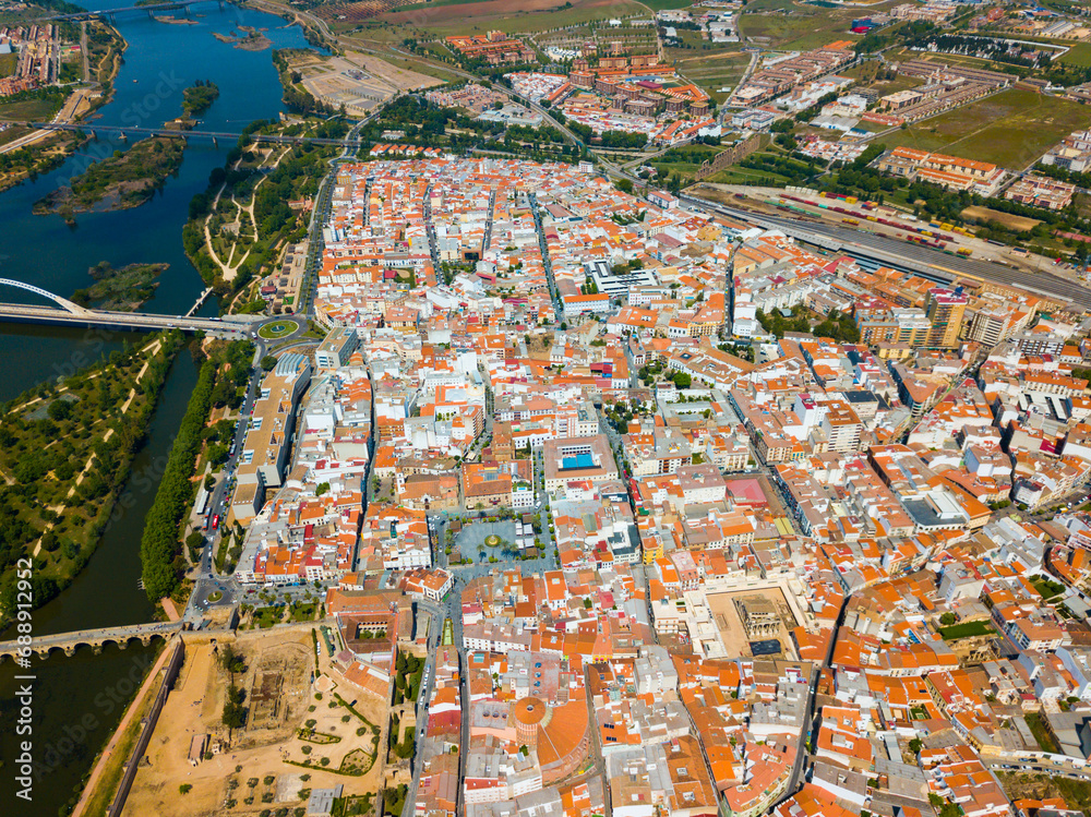 Scenic aerial view of Spanish city of Merida with ancient Roman Bridge and modern Lusitania Bridge over Guadiana river