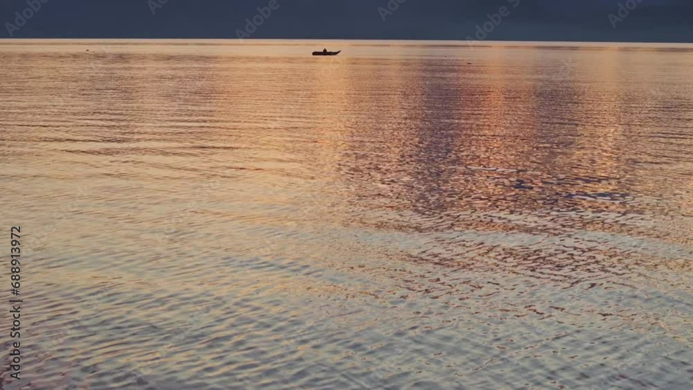 Reveal shot of Lake Atitlan Guatemala with fishing boat during sunrise, aerial Reveal shot of Lake Atitlan Guatemala with fishing boat during sunrise, aerial