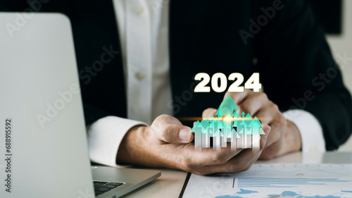 Businessman analyzing the profitability or cost of a working company 2024 with hands pointing at a higher target.