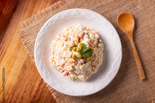 Russian Salad, also known as Olivier Salad. Very popular dish in several countries, the main ingredients are commonly potatoes, mayonnaise and vegetables such as peas, carrots, boiled eggs or chicken