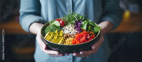 Woman with vegan or vegetarian food. Plant-based diet. Healthy meal. Buddha bowl with fresh veggies. Healthy eating.