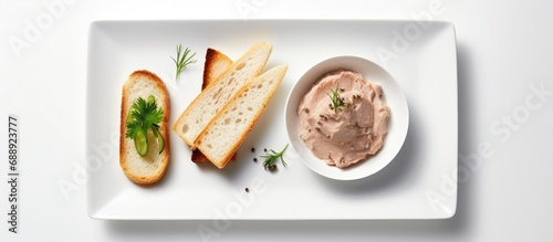 Tuna pate, fish rillettes, and a sandwich on a white plate viewed from the top.