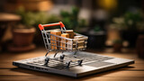 Online shopping concept with miniature shopping cart standing in front of laptop.