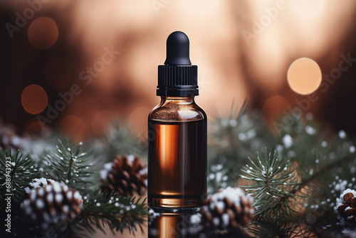 Pine essential oil in a glass bottle on the background of Christmas decorations.
