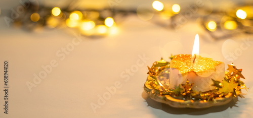 christmas candles on the table with lights in the background