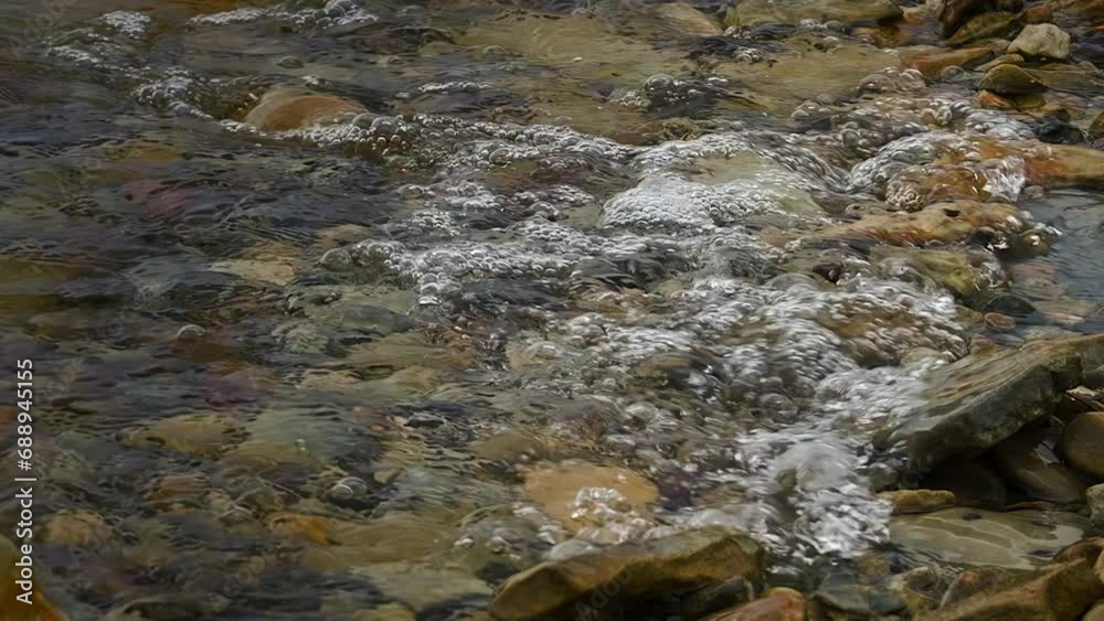 Clear Lake Water Splashing On Stones. closeup, slowmo shot Clear Lake Water Splashing On Stones. closeup, slowmo shot