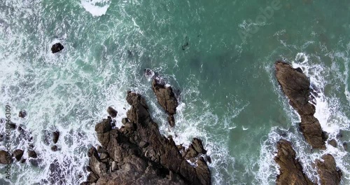 4K Drone Footage of Pacific ocean waves crashing on rocky cliffs in Brookings Oregon photo