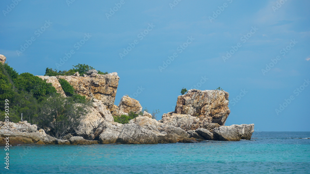 Rocks on the beach. Beautiful tropical beach at exotic island. Blue sea waves on the rocky coast, beautiful seascape. the tropical sea coast island, Koh Samed island, Thailand. Rocks on the beach. Beautiful tropical beach at exotic island. Blue sea waves on the rocky coast, beautiful seascape. the tropical sea coast island, Koh Samed island, Thailand.