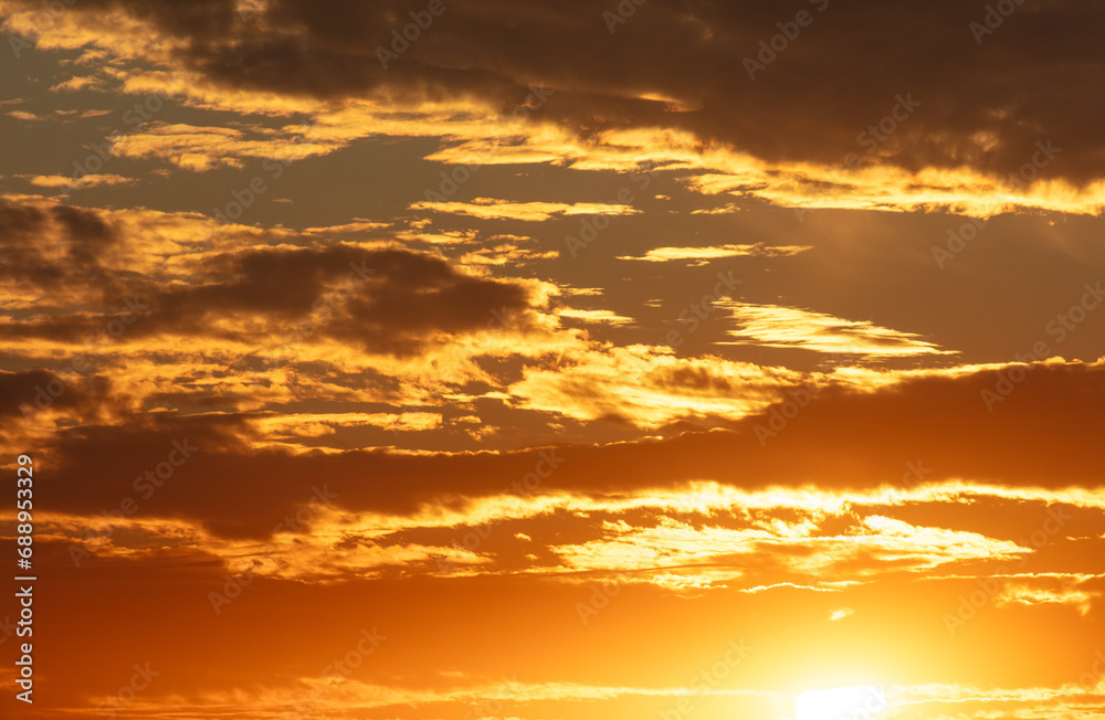 Golden sunset on the sky with clouds