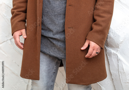 Male hands in a brown jacket