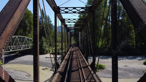 Drone flying through a Railroad Bridge above the Nooksack River in the Cascade Mountains, Washington State photo