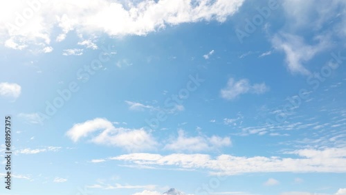 Looking At At Blue Skies With Clouds With Pan Down To Reveal Osorno Volcano Beside Lake Llanquihue In The Distance photo
