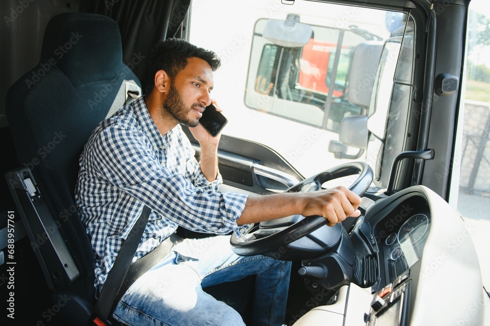 Indian truck driver tending a client on the phone Indian truck driver tending a client on the phone